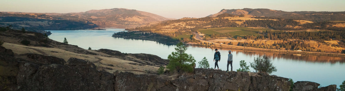 People walking outdoors along a river.
