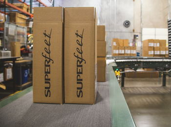 Superfeet shipping boxes on conveyor belt