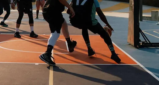 People playing basketball on a basketball court