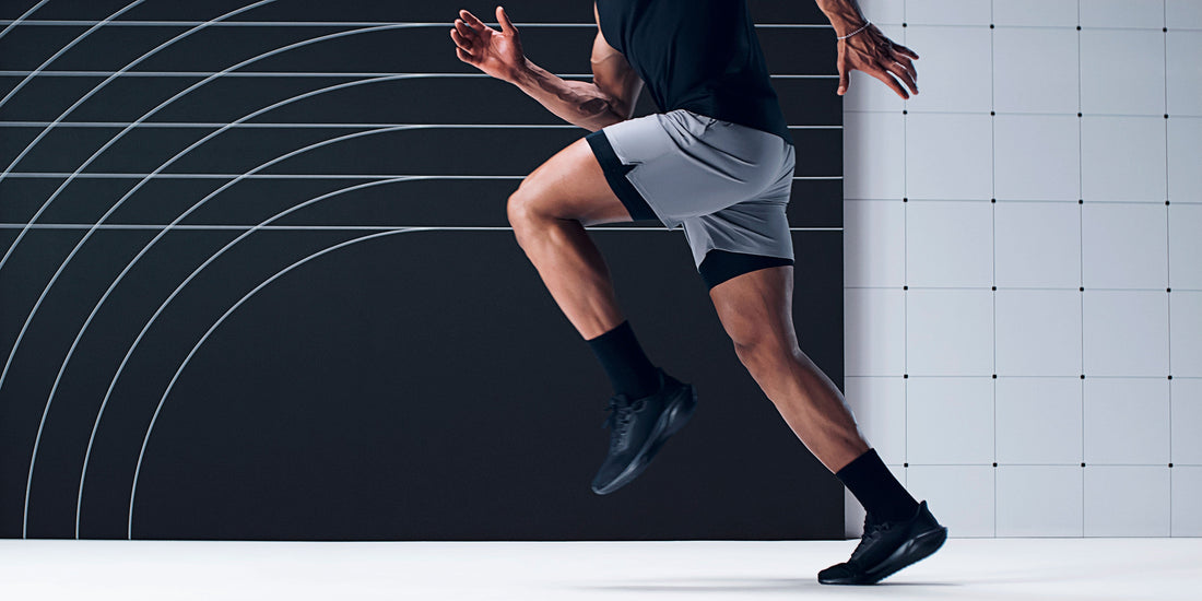 Person running in a studio on a white floor with a black and white checkered background
