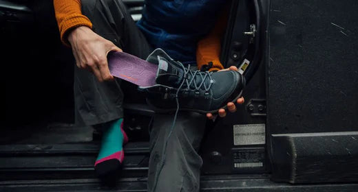 A Superfeet insole being placed into a boot