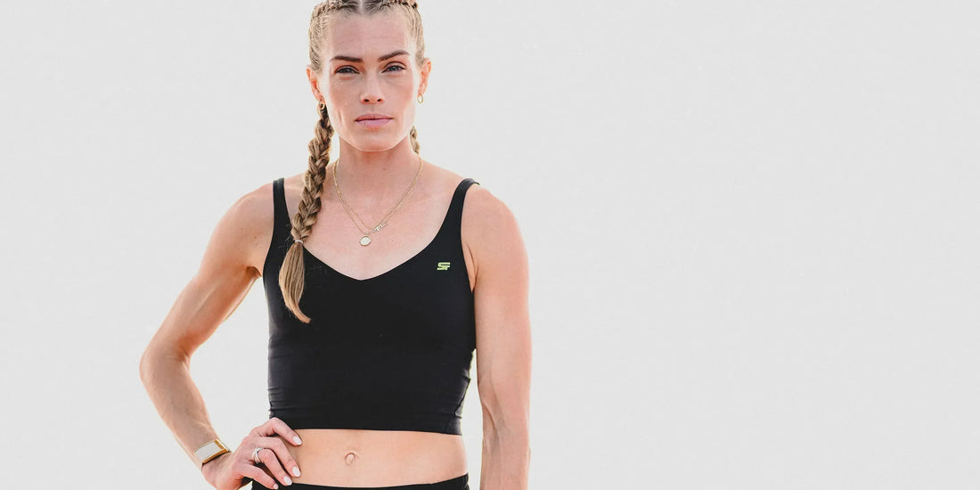 Image of Olympian Colleen Quigley in black athletic wear in front of a white background