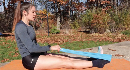 Woman demonstrating a stretching techique to fix plantar fasciitis pain.