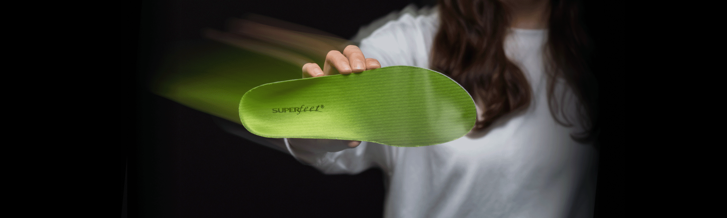 Gif of people holding different green, blue, and black all-purpose Superfeet insoles.