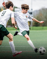 Two young soccer players in action on a field
