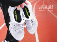 Someone standing on a track holding Superfeet's Run Pacer Insole inside of a white running shoe. Text Reads "Energized Cushioning Land Soft & Springs Back Fast"