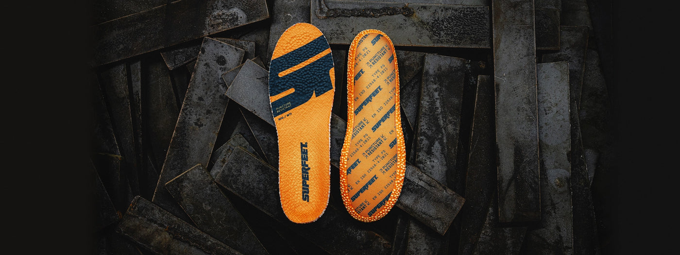 The front and back of Superfeet's Work Puncture Resistant Insole against a dark grey background.