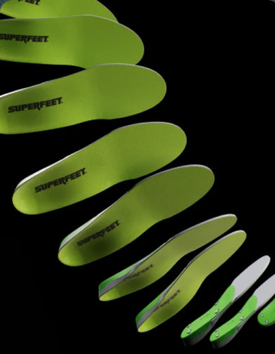 Green insoles with 'Superfeet' branding on a black background