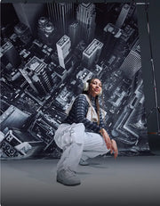 Person posing in front of a cityscape backdrop