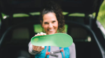 Person holding a Superfeet insole up to the camera