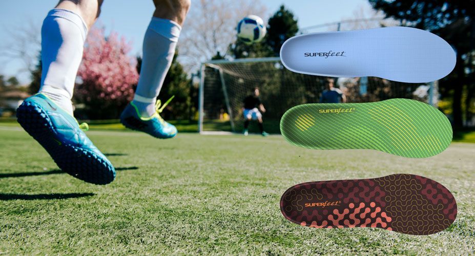 Foot kicking a soccer ball with three Superfeet insoles displayed