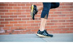 Woman's running shoes running on sidewalk