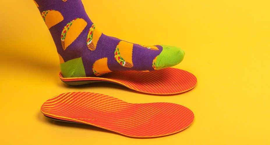 Foot with taco sock stepping onto Run Pain Relief insole