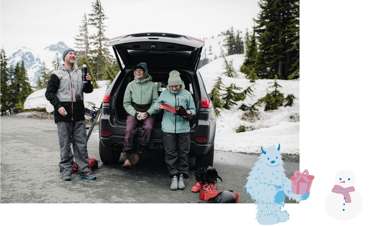 Three skiers around an open SUV tailgate after shredding fresh pow all day long