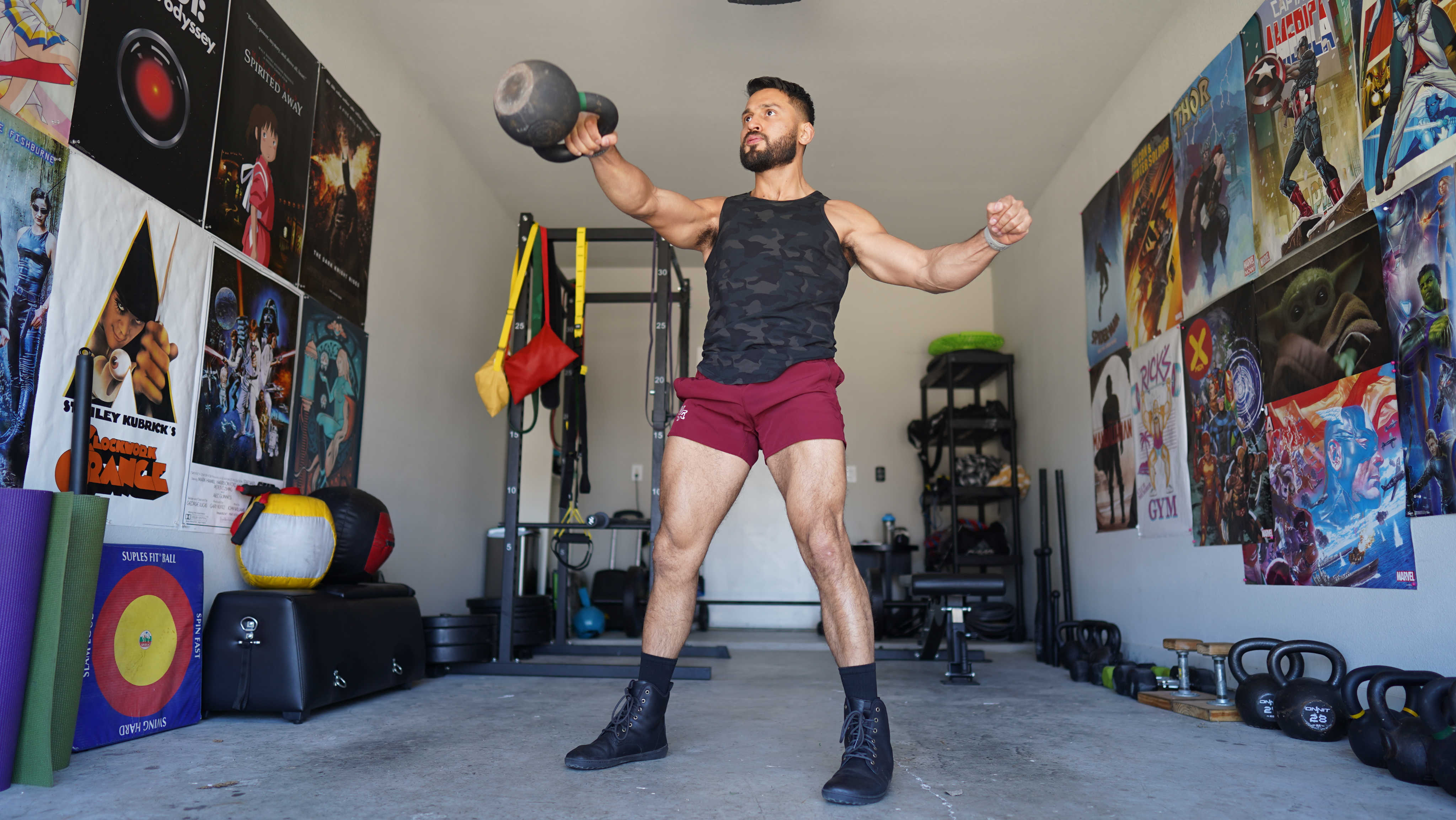 Eric does a kettlebell swing in his garage gym