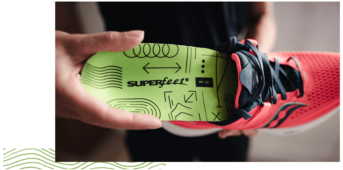 Person inserting ME3D insole into red running shoe