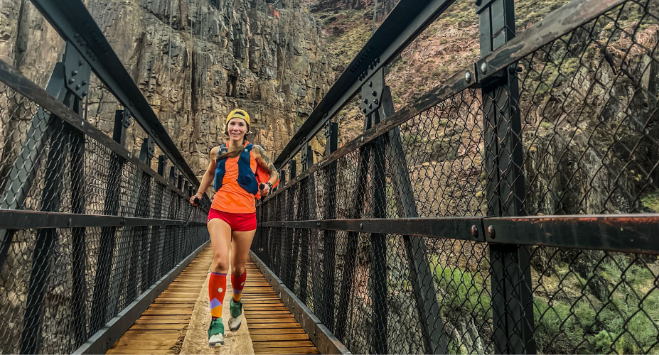 Smiling trail runner on an old pedestrain bridge